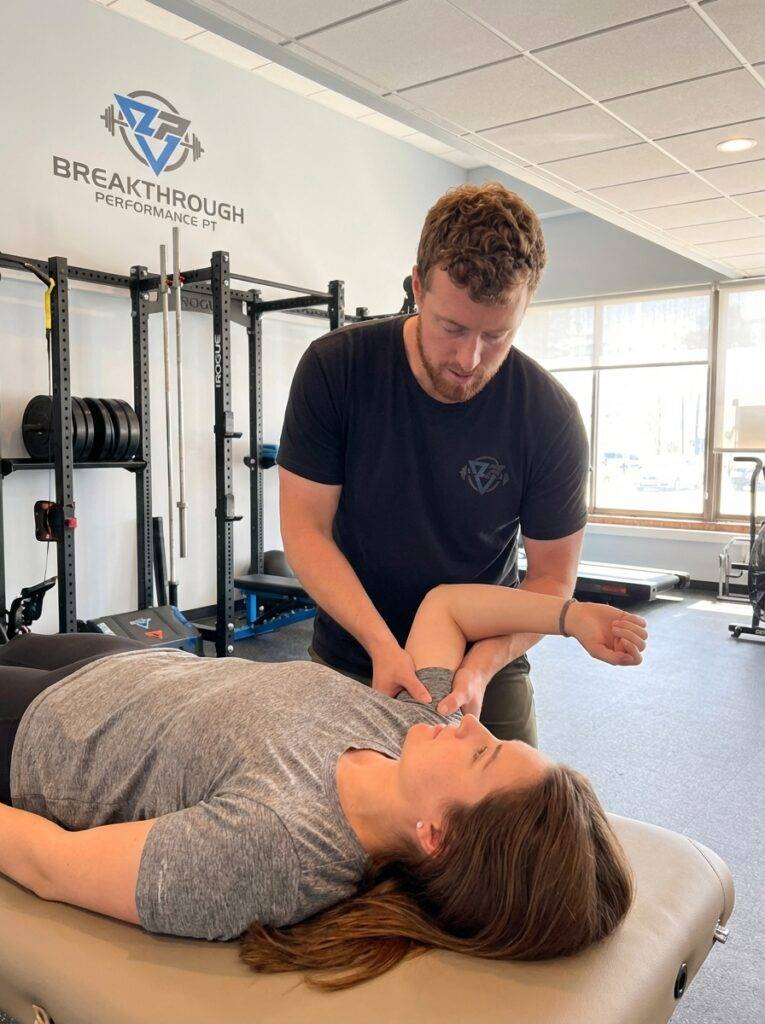 Patient working with a provider at a physical therapy clinic in Asheville performing therapeutic exercise