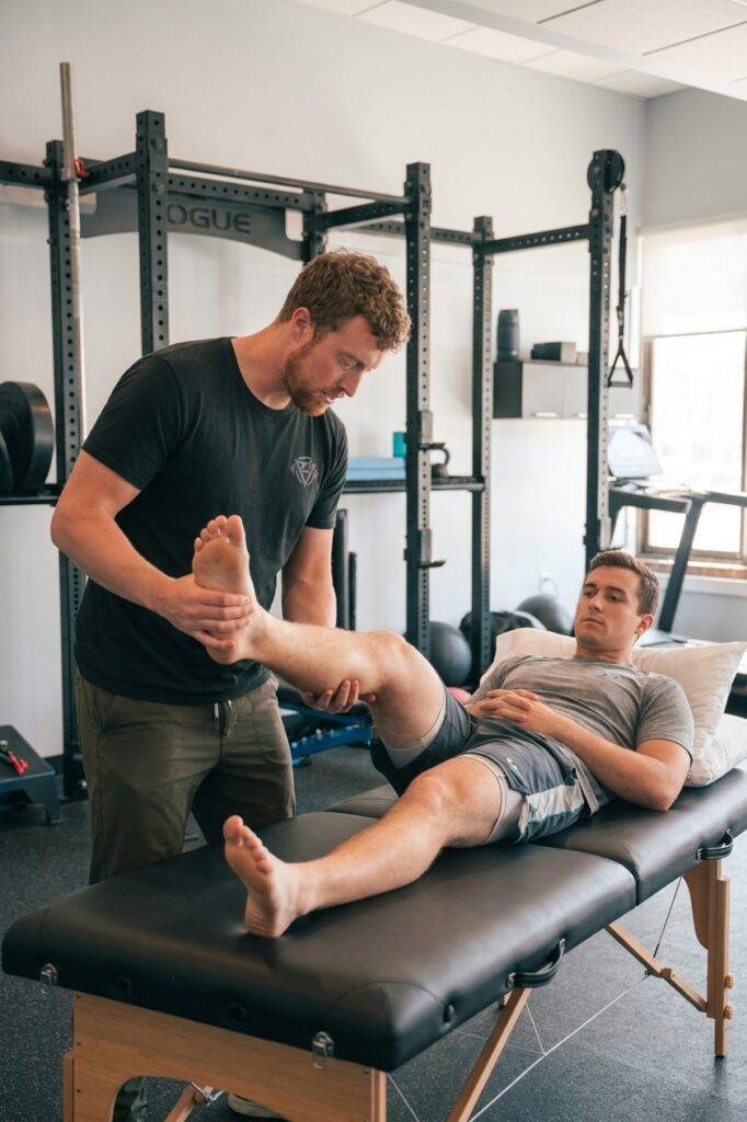 Patient receiving lower extremity assessment from a physical therapist at a physical therapy clinic in Asheville, NC